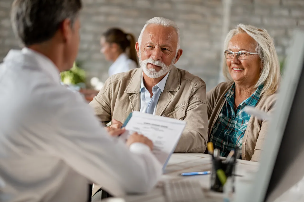 Doctor consulting with an older couple about their healthcare needs and treatment options