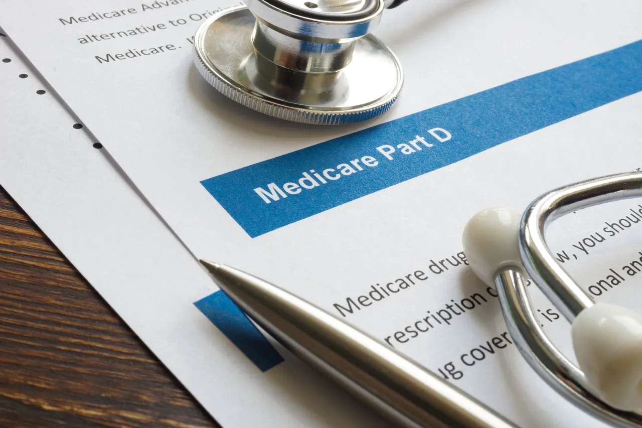 Stethoscope and pen placed beside Medicare Part D prescription drug coverage documents